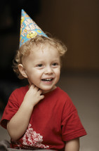 Cute happy young boy in a party hat
