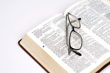 reading glasses on a Bible 