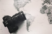 camera with lens on a world map 
