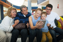 Big family entertaining with touch pad at the airport