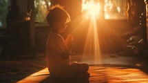 Little boy praying at sunset. Religious and spiritual concept.