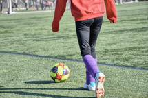 a girl with a soccer ball 