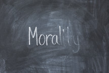 erasing the word morality off a chalkboard 