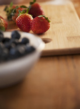 strawberries and blueberries in a kitchen 