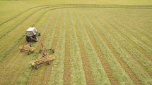 A field being harvested with a combine tractor.