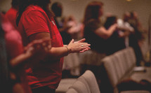 Praying hands at a worship service. 