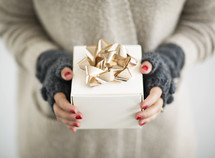 a woman holding a gift box 