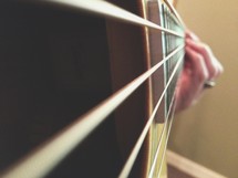 hand playing a guitar 