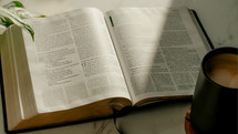 opened Bible and coffee cup 