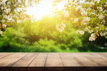 Natural Wood Background with Green Tones and Selective Focus. The backdrop showcases lush foliage with a bokeh effect. An empty wooden table offers spaciousness and tranquility