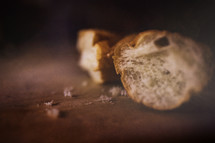 Broken bread on a table.
