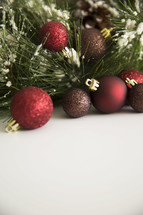Christmas tree and glittery Christmas ornaments on a white background 
