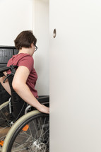 disabled woman going through a door 