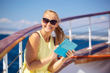 Happy woman with pad during sea traveling
