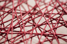 close up of intertwined red string.