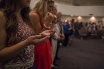 Hands extended during worship service.