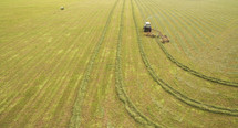 A field being harvested by a combine harvester.