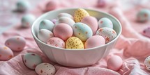 Easter eggs painted in pastel colors in a bowl on a pink background