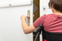 disabled woman opening a door 