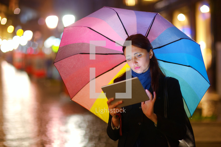 Woman with Tablet PC in the Rain