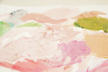 Colorful paints on a white canvas.
