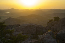 sunset over rocks on a mountain top 
