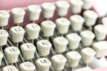 keys on a pink typewriter 