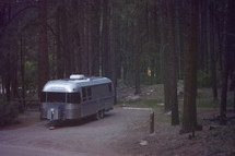 a camper in a forest 