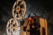  White film reels rotating.Old-fashioned 8mm movie projector playing bobbin tape