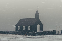 a church in the falling snow 