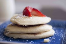 strawberries on a stack of pancakes 