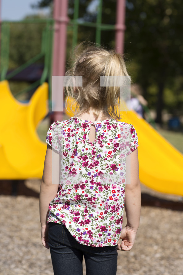 a girl approaching a playground 