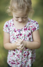 a child with praying hands 