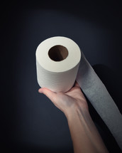 arm holding a toilet paper 