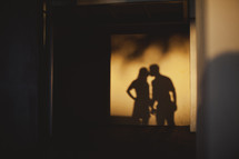 A shadow of a couple kissing