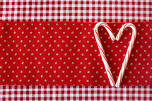 heart shape candy canes on red fabric 
