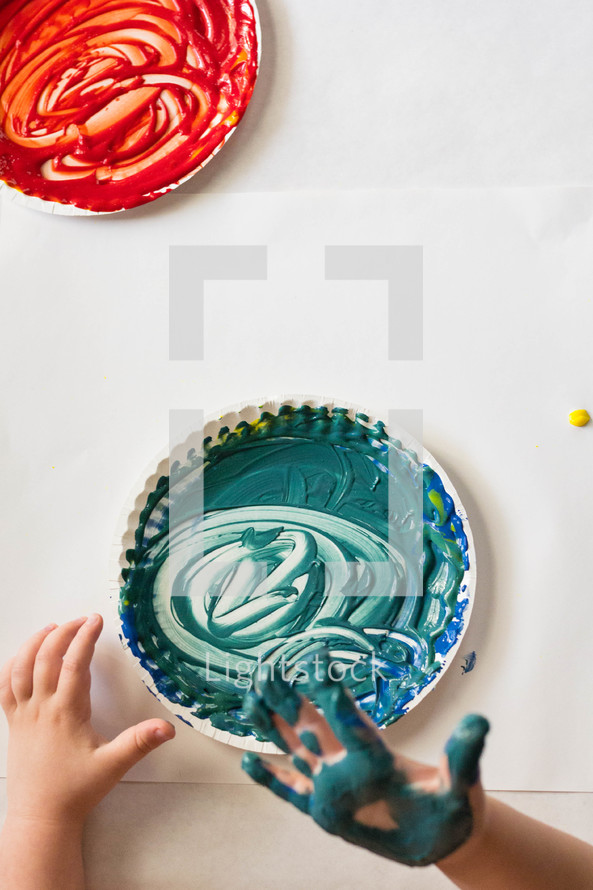 red and blue finger paint on paper plates 