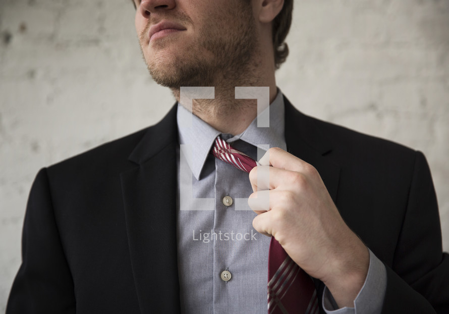 businessman taking off his tie 