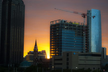 construction crane on a skyscraper at sunset 