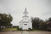 A small, white church in a rural area.