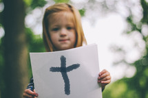 girl holding a cross on paper 