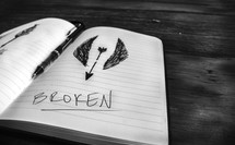 broken arrow drawn on a journal 