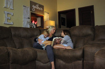 a mother reading a Bible to her daughters 