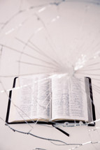 Bible and cracked glass