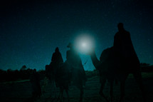 wisemen traveling on camels under the stars 