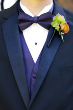 Men's tuxedo purple vest bowtie boutonniere on lapel