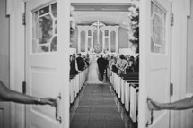 A bride and her father walking down an aisle