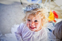a toddler girl dressed as an angel in a nativity scene 