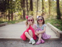 children in sunglasses sitting outdoors 