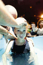 A girl being baptised.